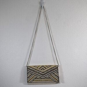 America and Beyond Embellished Convertible Clutch w/ Strap New w/ Tags has flaws